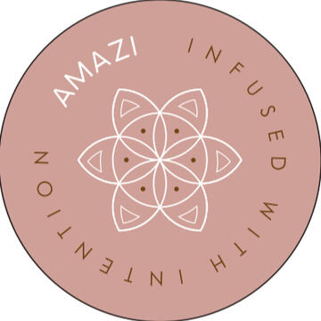 AMAZI Sacred Tea Bottles with Flower of Life Design Two AMAZI glass tea bottles with Flower of Life engraving on blue bench, filled with fresh herbs and lemon water, surrounded by ritual tools including wooden spoon and sacred geometry cards